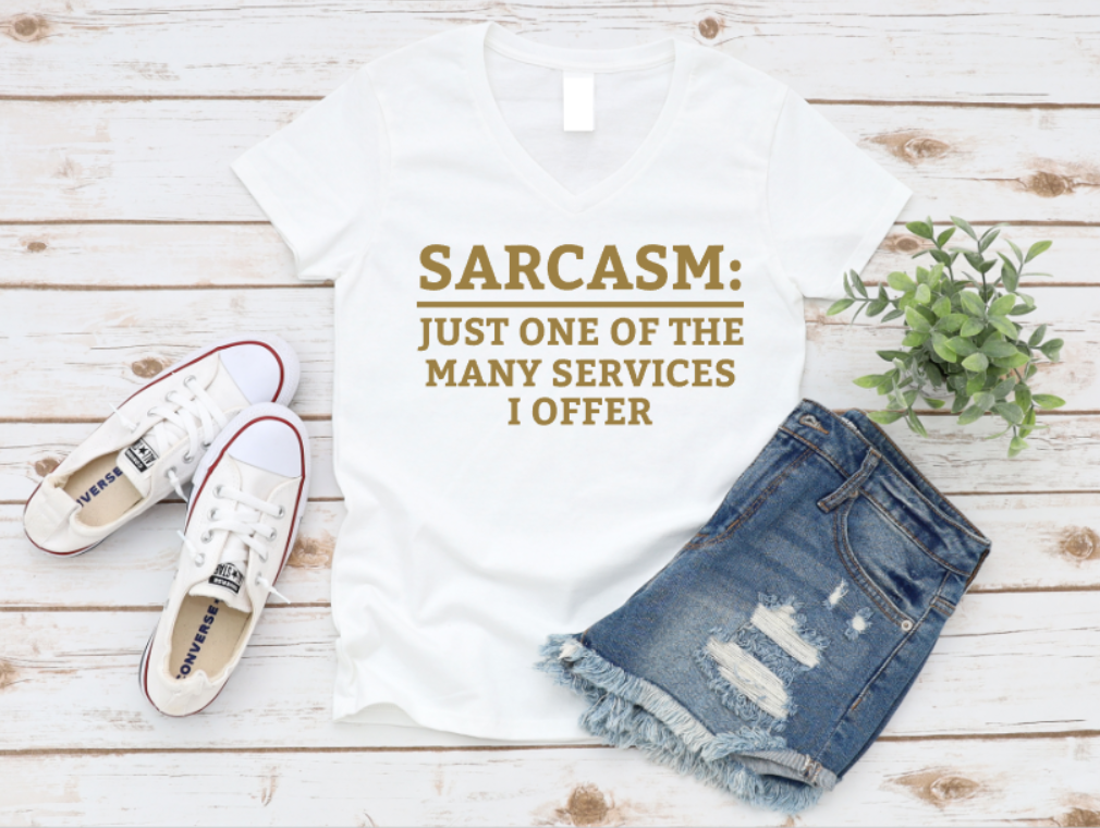 White t-shirt with humorous text, denim shorts, and white sneakers on a wooden surface. www.missmafia.com