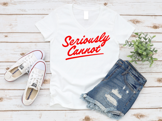 White t-shirt with 'Seriously Cannot' text, white sneakers, and denim shorts on a wooden surface. www.missmafia.com
