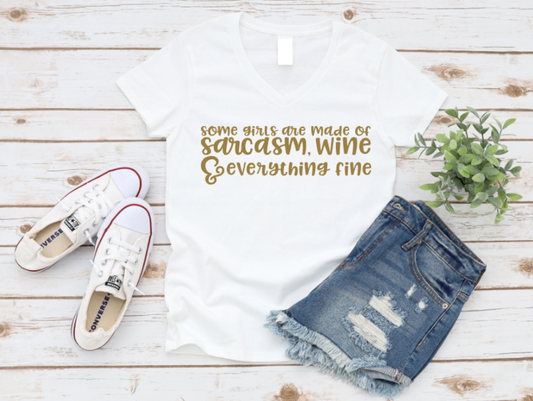 White t-shirt with text, denim shorts, and white sneakers on a wooden surface. www.missmafia.com