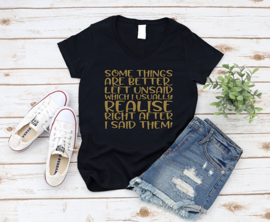 Black t-shirt with gold text, white sneakers, and denim shorts on a wooden surface. www.missmafia.com