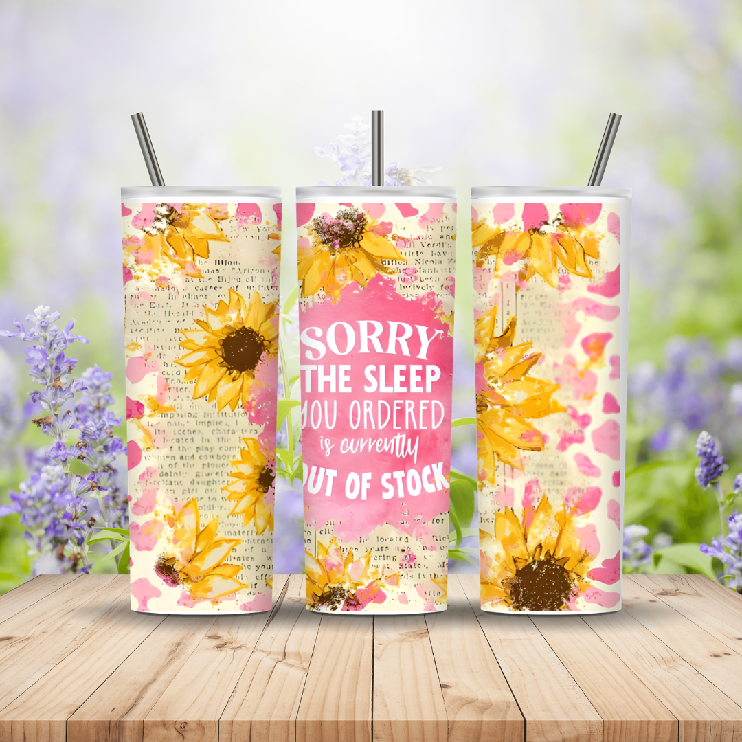 Three floral-themed tumblers with sunflowers on a wooden surface with a blurred natural background.