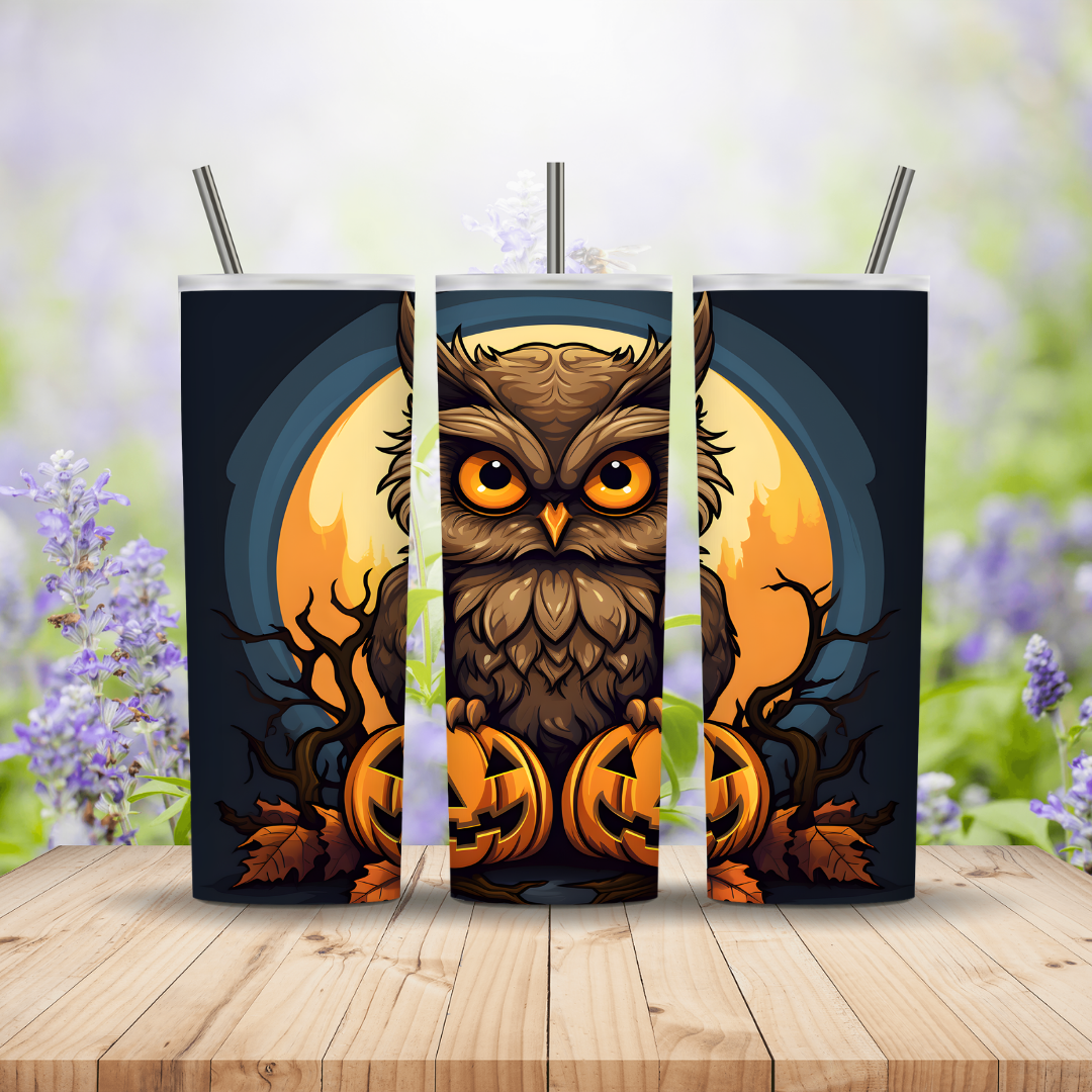 Three tumblers with an owl design on a wooden surface with a blurred floral background