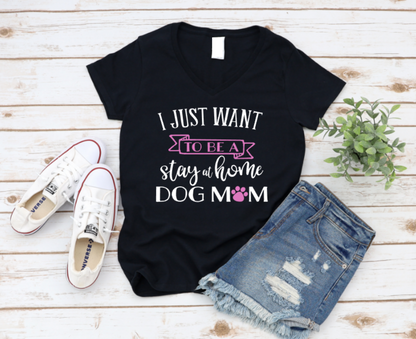 Black t-shirt with 'I just want to be a stay at home dog mom' text on a wooden surface with sneakers and shorts. www.missmafia.com