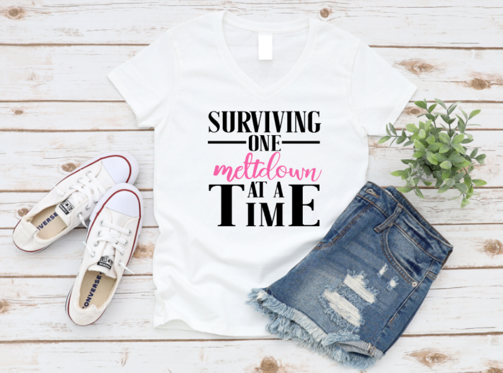White t-shirt with text, denim shorts, and white sneakers on a wooden surface. www.missmafia.com
