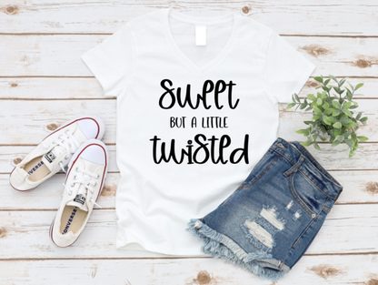 White t-shirt with 'Sweet But A Little Twisted' text, denim shorts, and white sneakers on a wooden surface. www.missmafia.com