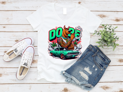 White t-shirt featuring a tattooed, muscular cartoon dog, smoking with bold “DOPE” text in the background, a green muscle car, smoke clouds, and weed leaves in a vibrant, urban graffiti style.