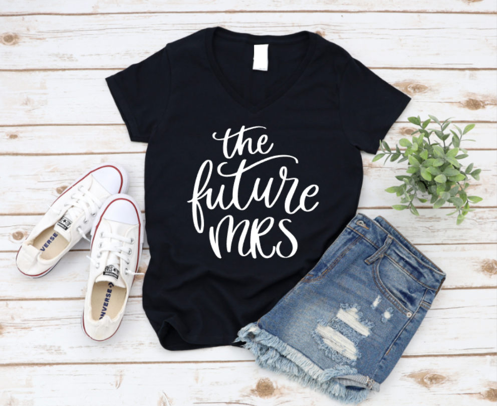 Black t-shirt with 'the future Mrs.' text, paired with denim shorts and white sneakers on a wooden surface. www.missmafia.com
