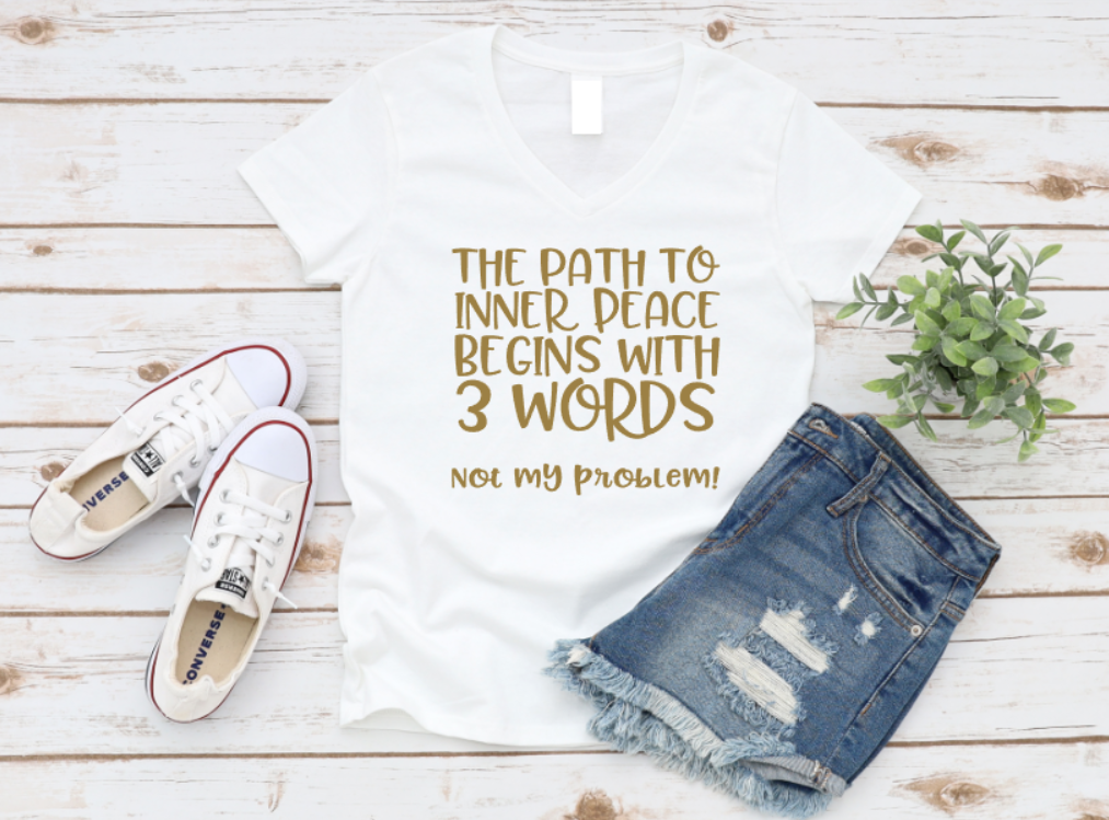 White t-shirt with motivational quote, white sneakers, denim shorts, and plant on wooden surface. www.missmafia.com