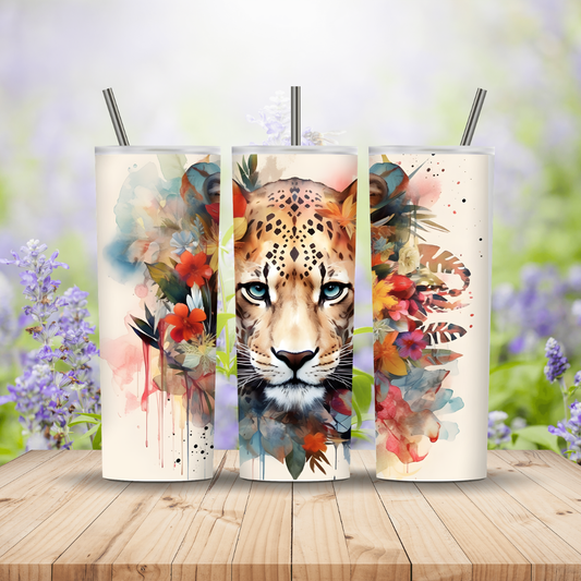 Three tumblers with a colorful animal design on a wooden surface with a floral background