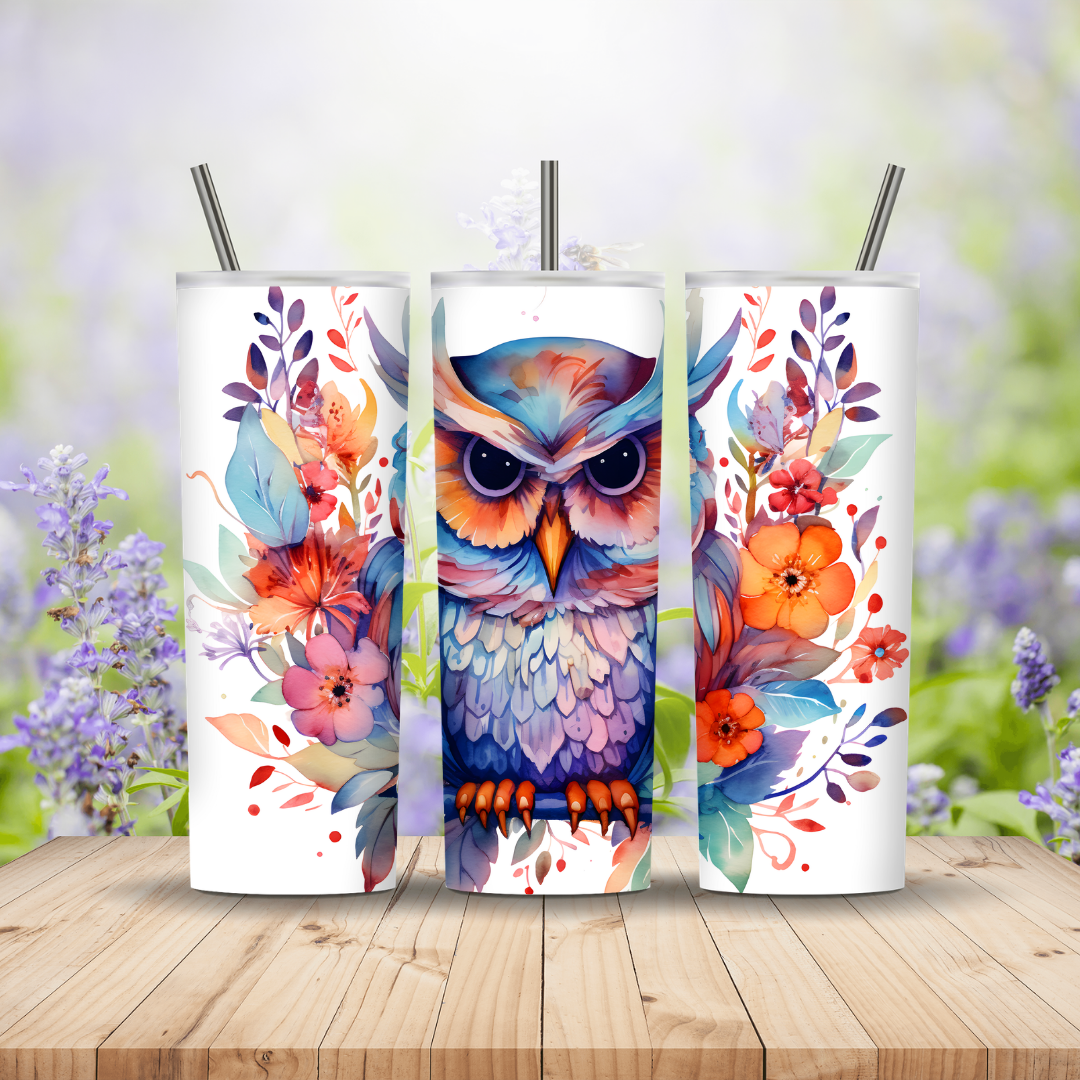 Three colorful tumblers with owl and floral designs on a wooden surface with a blurred nature background.