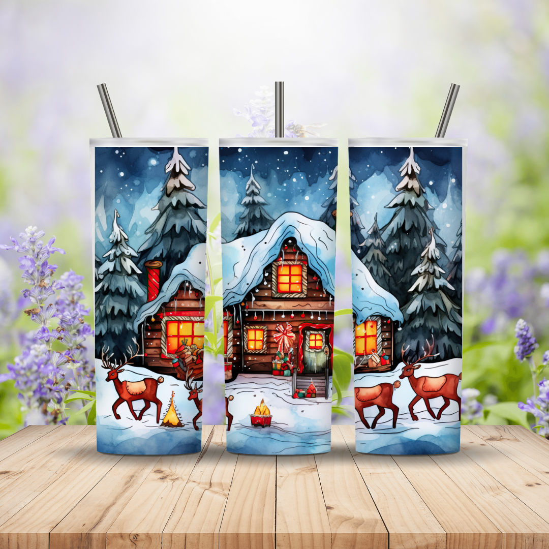 Three tumbler designs featuring a winter scene with a cabin, trees, and reindeer on a wooden surface.