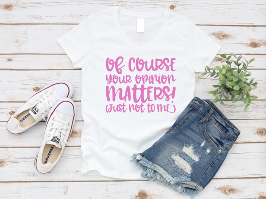 White t-shirt with pink text, white sneakers, and denim shorts on a wooden surface. www.missmafia.com