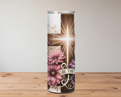 Christian tumbler with wooden cross, glowing light, pink and purple flowers, butterflies, and ‘Be The Light’ message