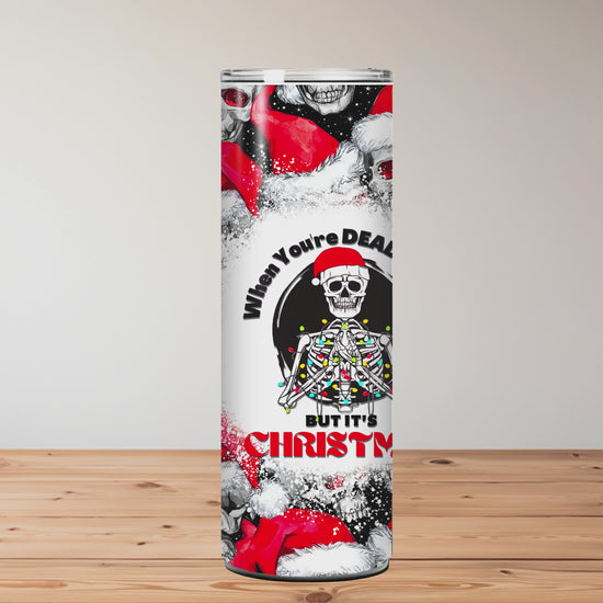 Tumbler with skull and Santa Claus design on a wooden surface background Miss Mafia
