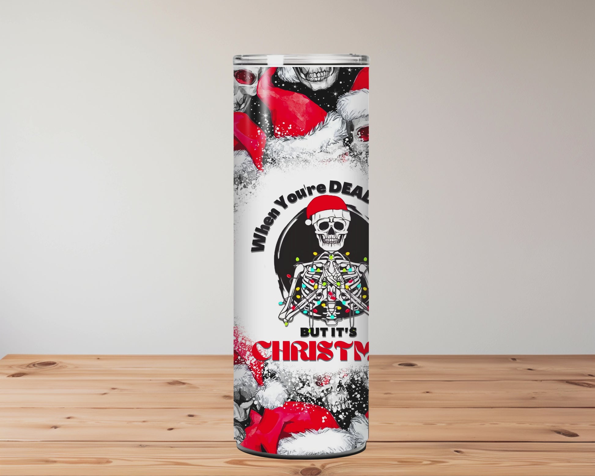 Tumbler with skull and Santa Claus design on a wooden surface background Miss Mafia