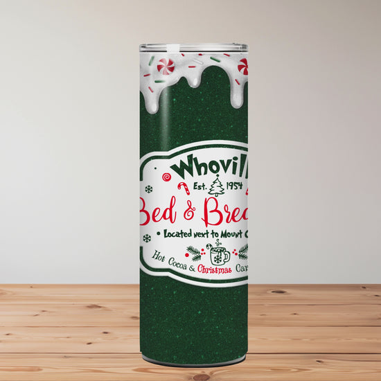 green tumbler with 'Whoville Bed & Breakfast' logo on a wooden surface