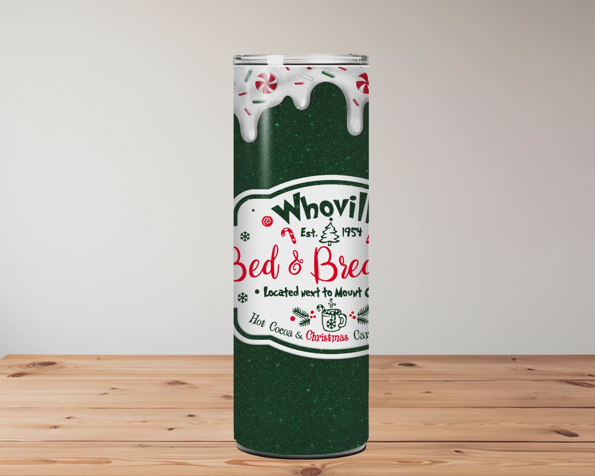 green tumbler with 'Whoville Bed & Breakfast' logo on a wooden surface