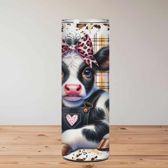 Tumbler design featuring a cow with a bow, sunflowers, and text 'Just a Girl Who Loves Cows' on a wooden surface Miss Mafia