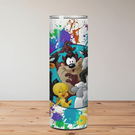 Colourful tumbler with cartoon characters on a wooden surface Miss Mafia