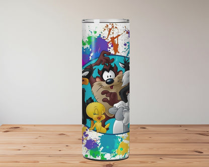 Colourful tumbler with cartoon characters on a wooden surface Miss Mafia