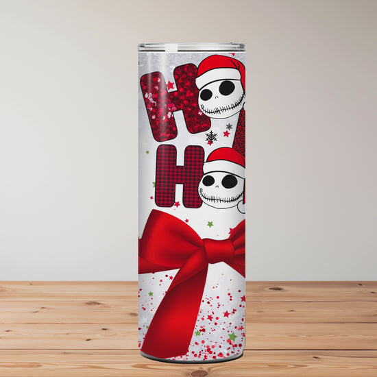 This sublimation tumbler features Santa-hat skulls, “Ho Ho Ho” text, a red bow, and festive confetti – a perfect goth-meets-Christmas 20oz cup.