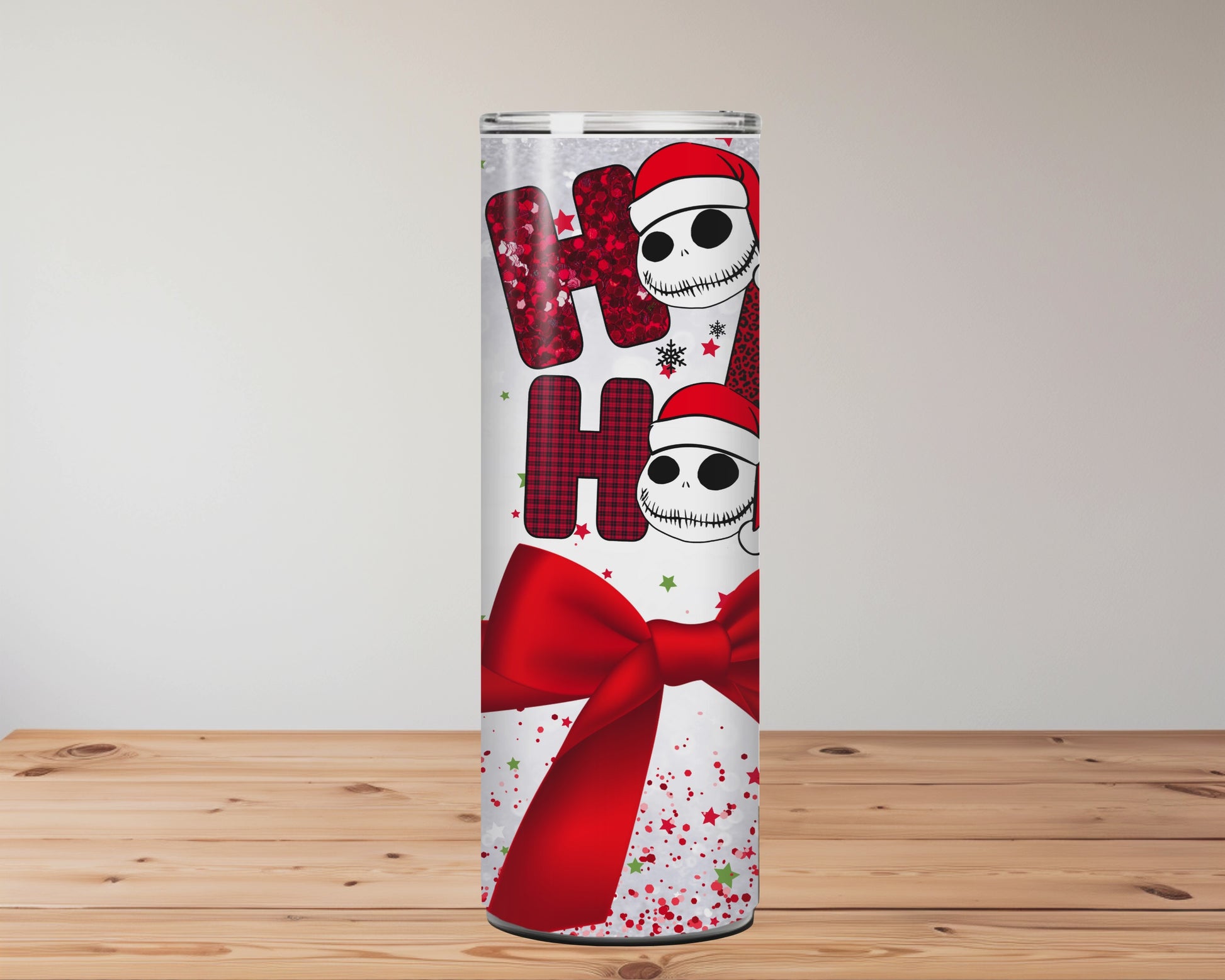 This sublimation tumbler features Santa-hat skulls, “Ho Ho Ho” text, a red bow, and festive confetti – a perfect goth-meets-Christmas 20oz cup.