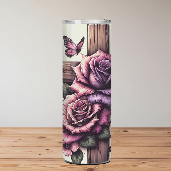Tumbler with floral designs and text on a wooden surface Miss Mafia