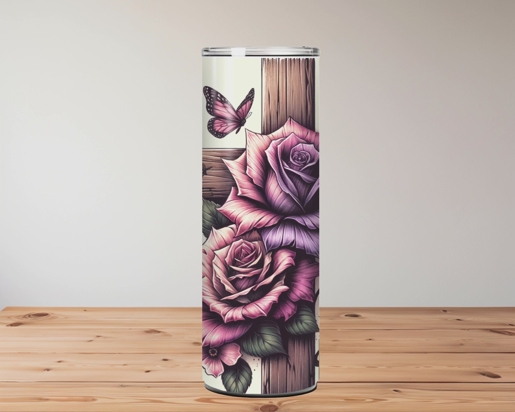 Tumbler with floral designs and text on a wooden surface Miss Mafia