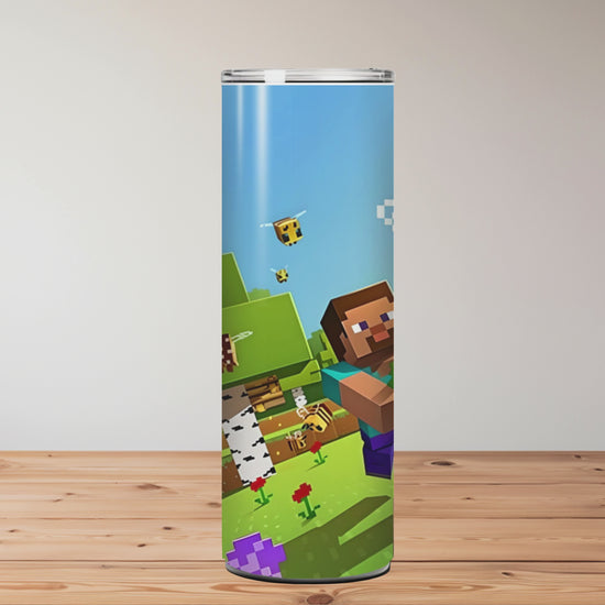 Three colourful tumblers with Minecraft-themed designs on a wooden surface. Miss Mafia
