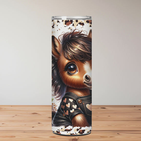 Tumbler with a horse design and floral elements on a wooden surface. Miss Mafia